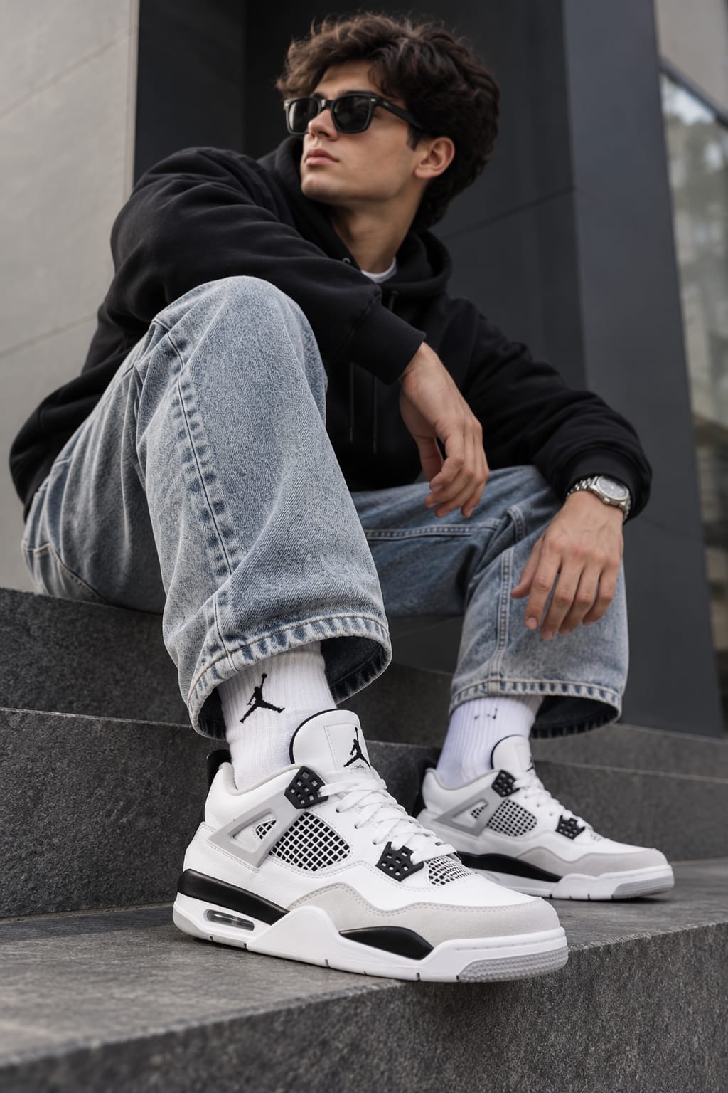 A customer in a pair of Air Jordan 4 Retro sneakers